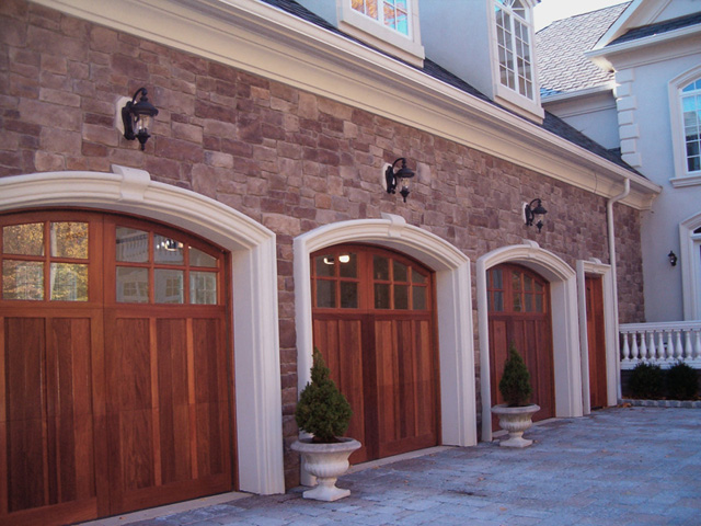 Large garage with three wooden doors