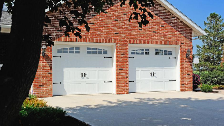 Two white carriage house-style garage doors