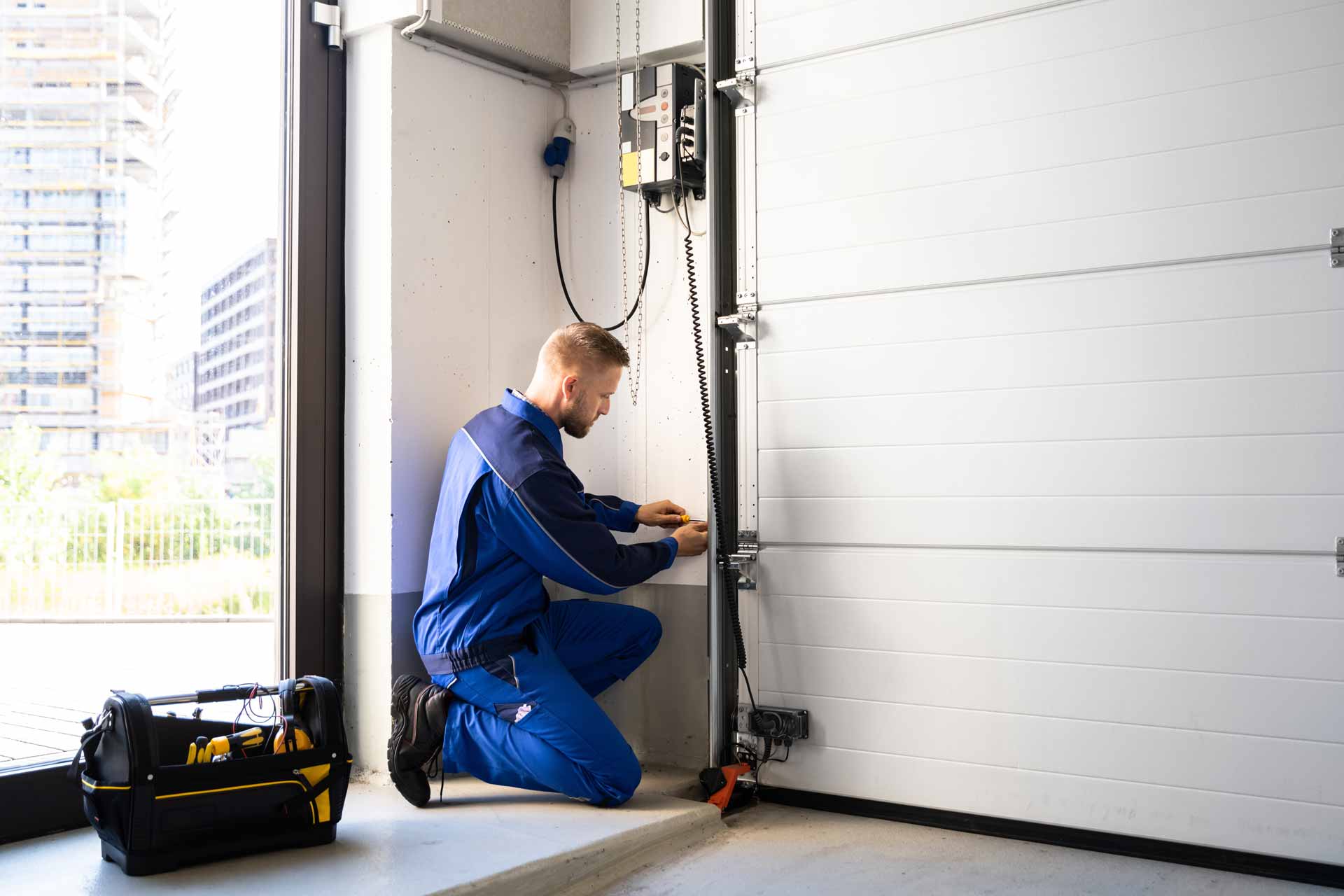 Technician repairs a garage door opener